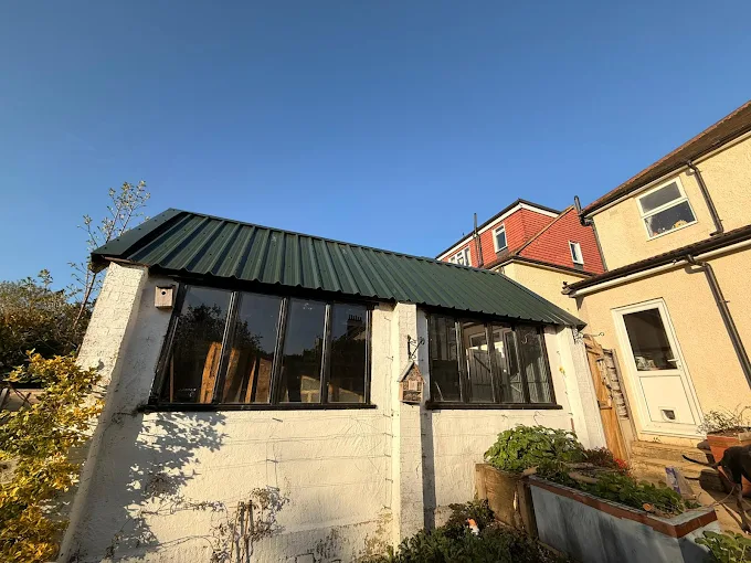 Replacement metal roof installed on outbuilding after asbestos removal